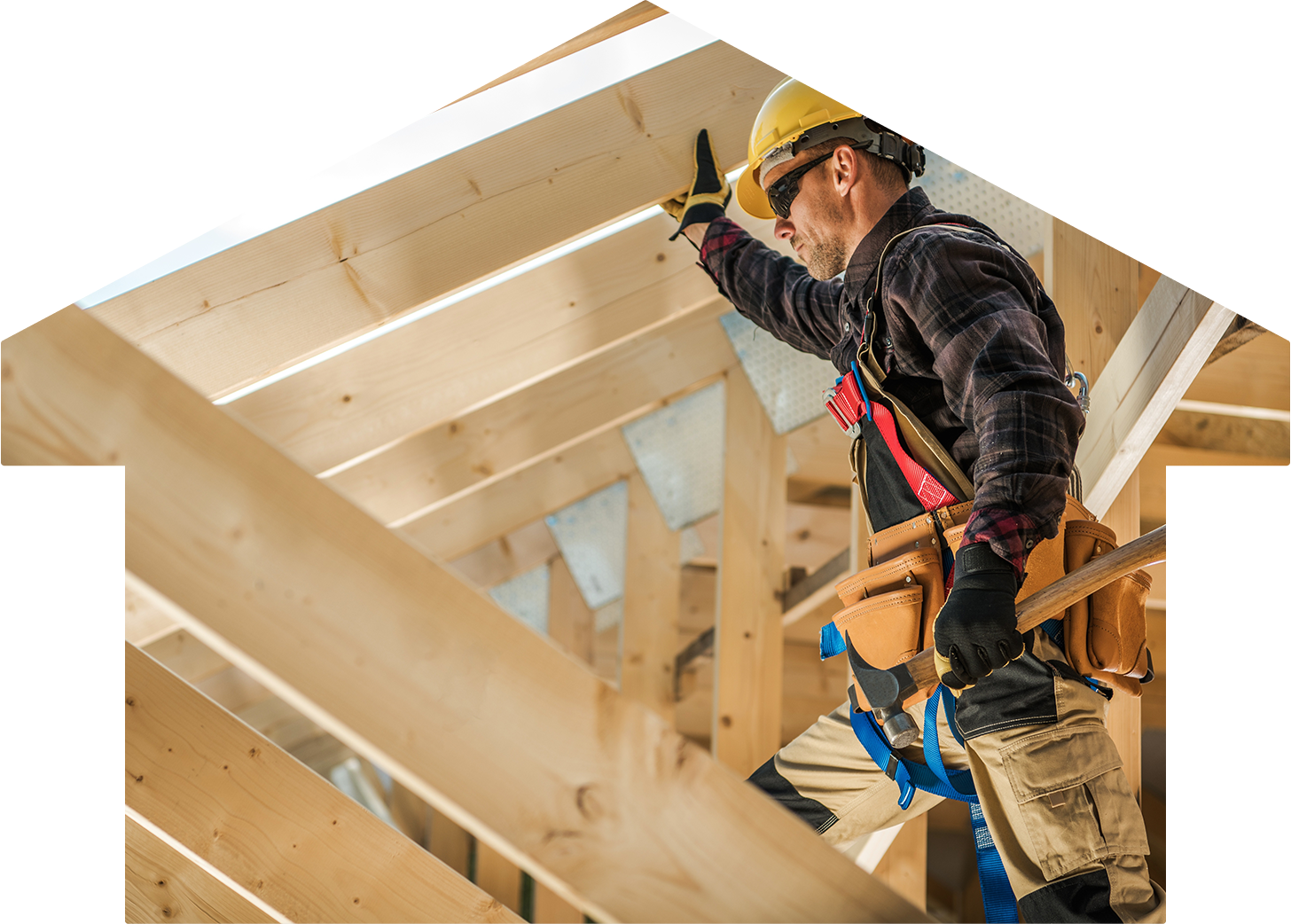 A construction worker standing in a frame of a house