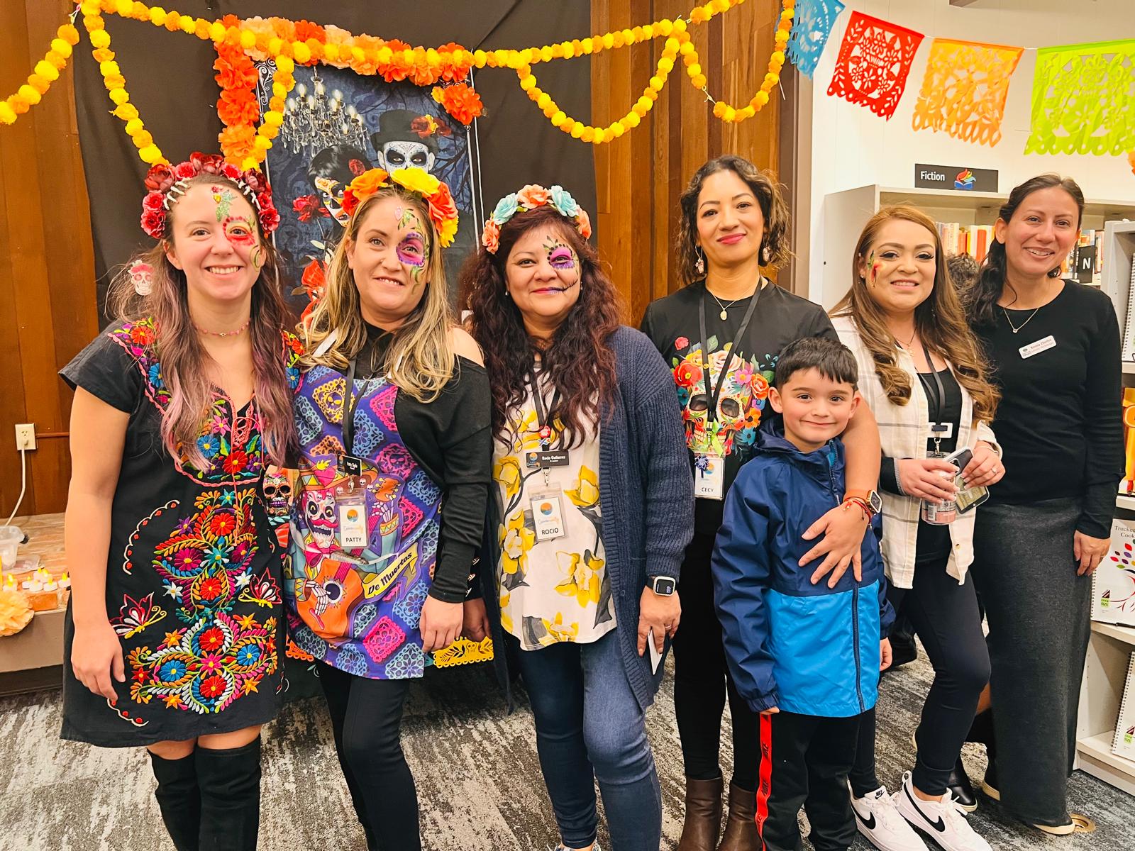 7 people smiling at the camera at the 2024 Día de los Muertos Fiesta with face paint. 