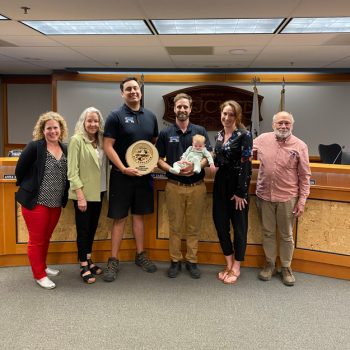 Members of Tahoe Moving & Storage accepting award with council members in Council Chambers. 