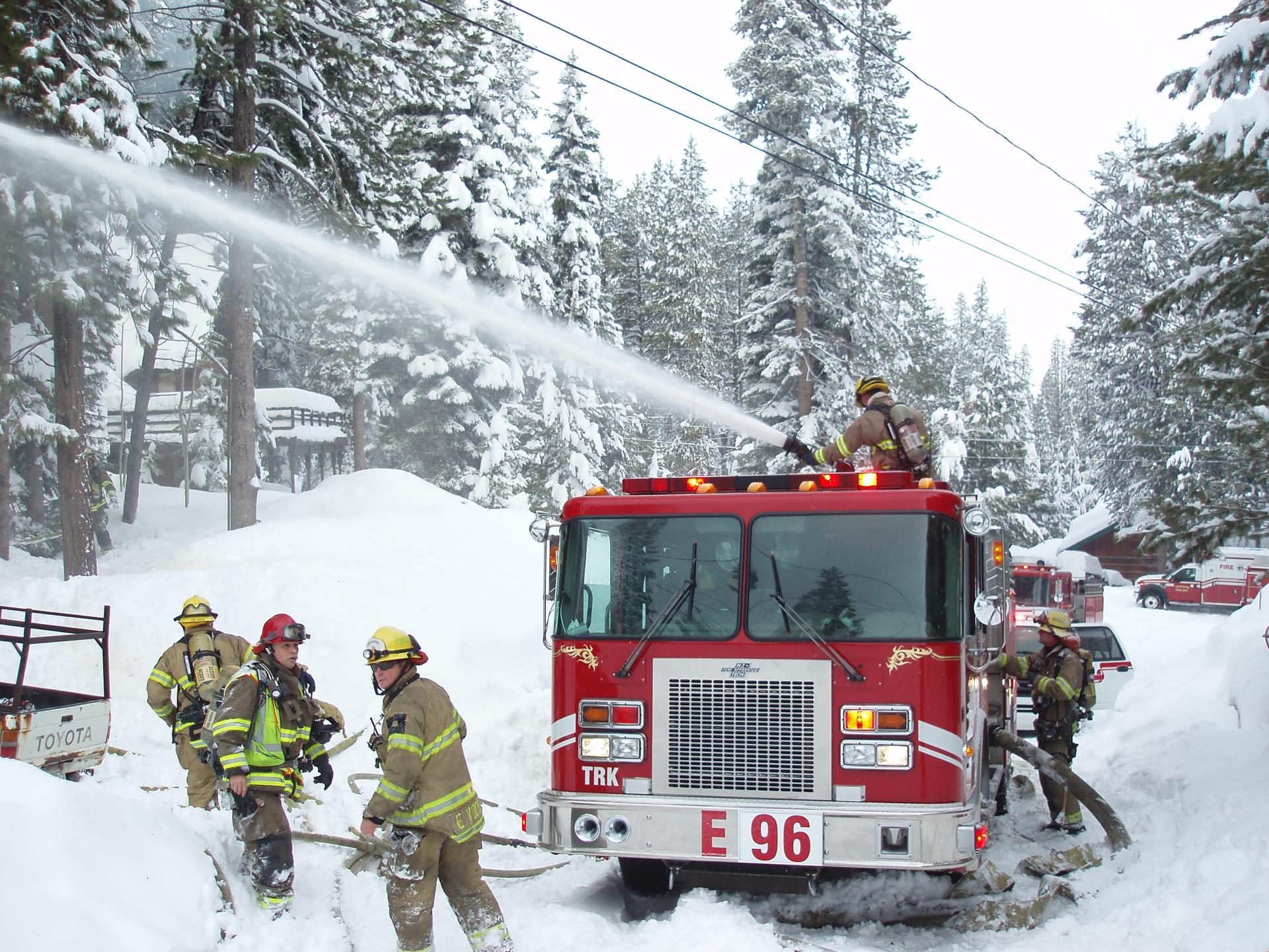 Fire Fighters Attending to an Emergency in the Winter