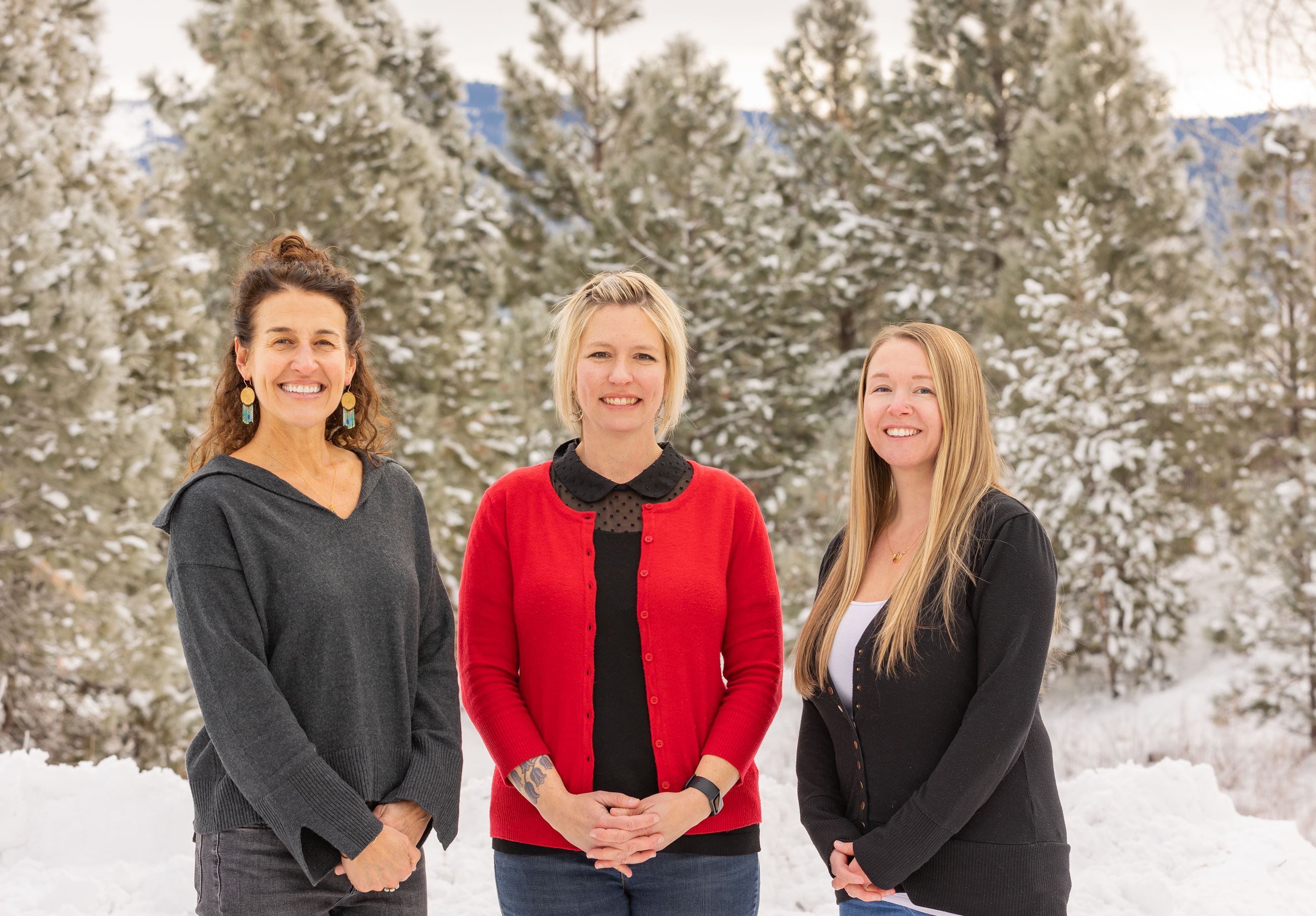 three women standing in a row in the snow. Kimmie Bullock, Bonnie Thompson-Harden & Christine Picard