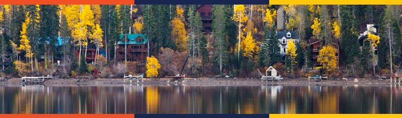 Houses on Donner Lake reflected in water with fall colors and yellow and orange border. 